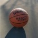 Pomarańczowa piłka do koszykówki Spalding React TF-250 76801Z r. 7 z czarnymi kanałami, fakturowaną powierzchnią i logo Spalding
